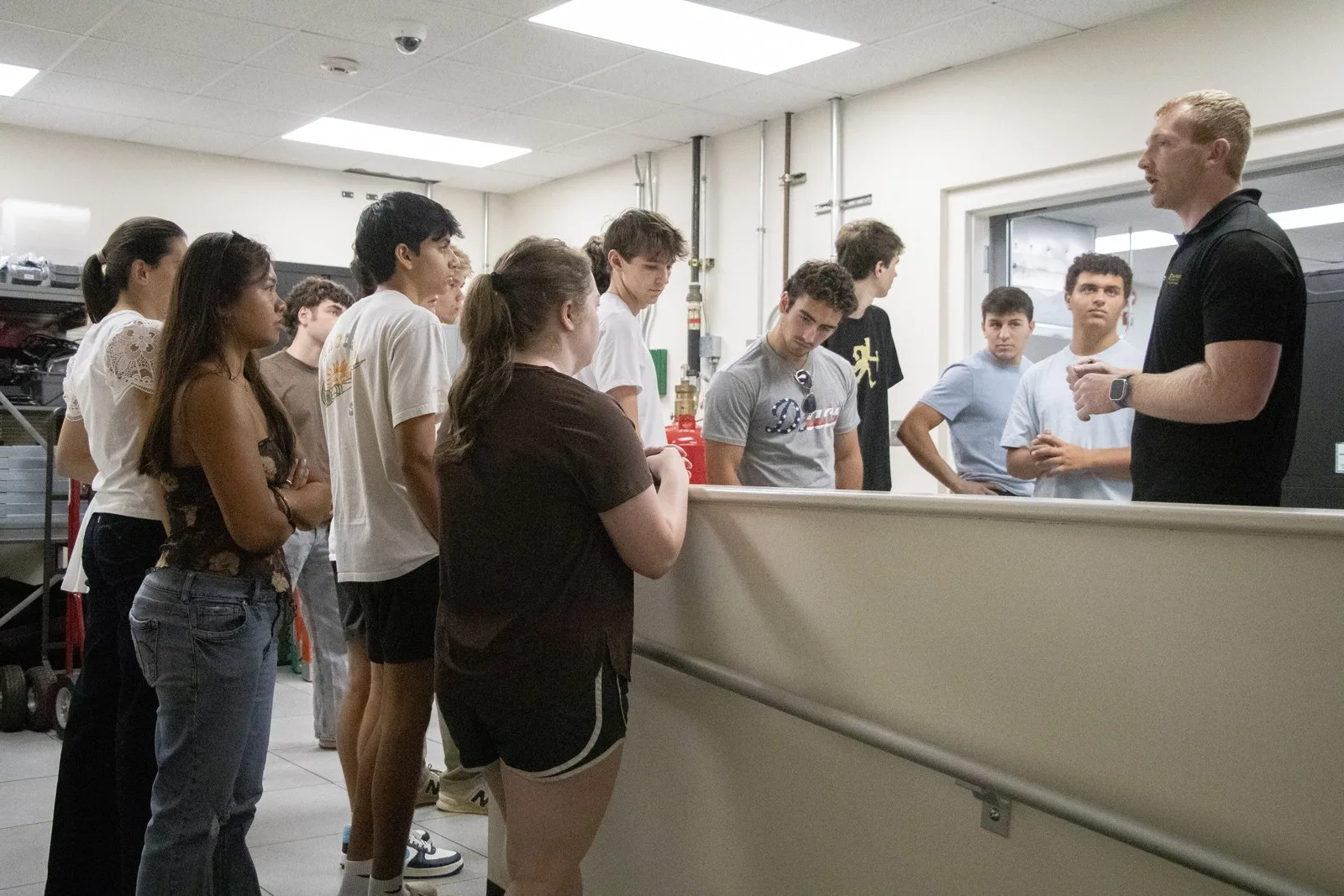 Students gather around an HPC staff member in the touchdown space.